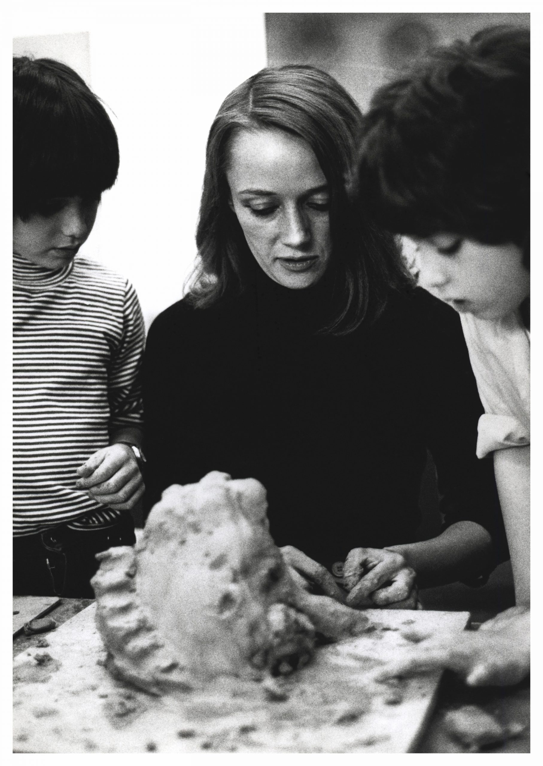 Niki de Saint Phalle and children in a workshop create models of monsters in clay