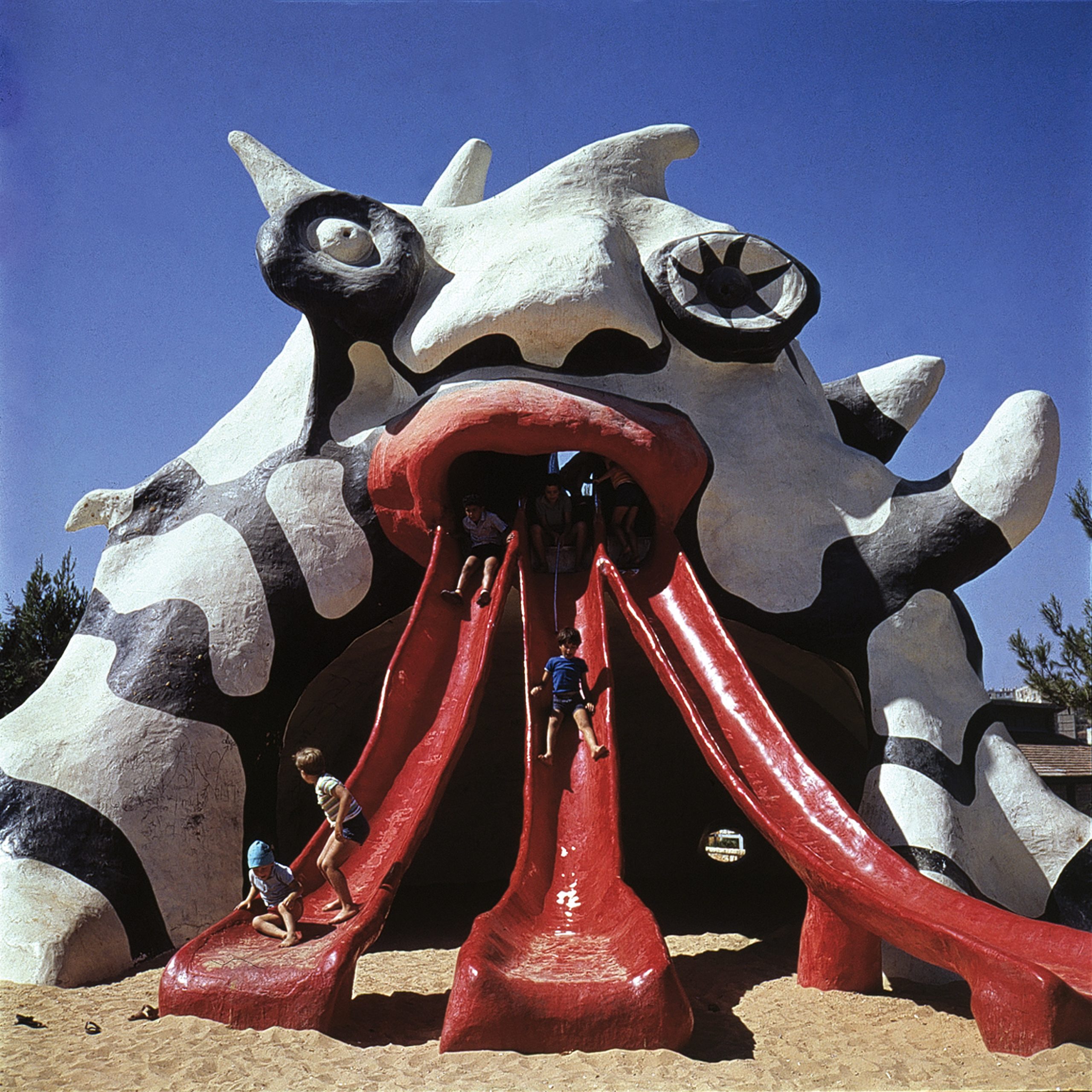 color photo of the finished Golem sculpture with children on the slides